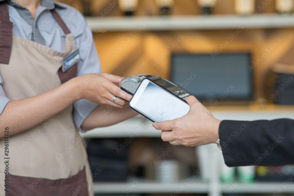 Obraz premium contactless payment by mobile phone in cafe