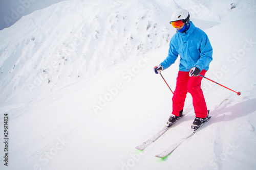 Sports man skiing on snowy slope.