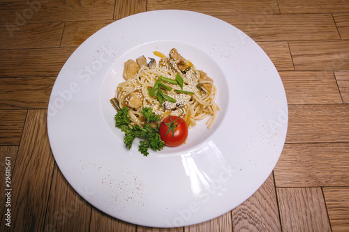 Plate with food on a wooden table.