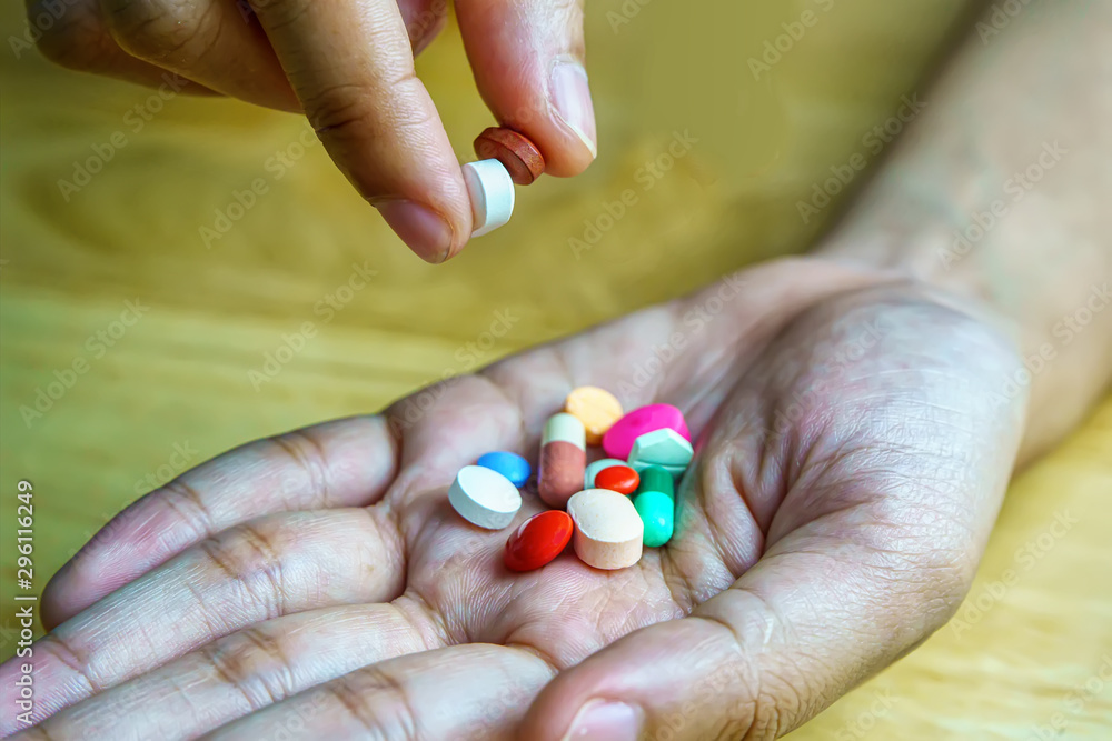 Drug prescription for treatment medication. Pharmaceutical medicament, cure in container for health. Pharmacy theme, Heap of multicolor round pills with medicine antibiotic on hand.