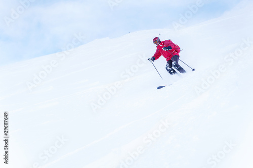 Photo of sports man with red backpack skiing