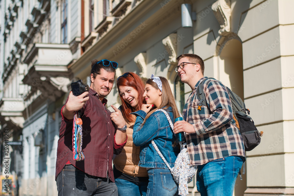 Happy multiracial friends group taking selfie