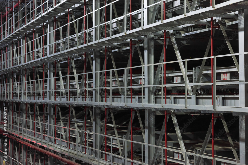 City modern large steel frame floor smart parking lot closeup City modern large steel frame floor smart parking lot closeup