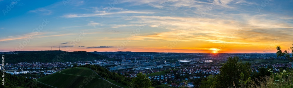 Germany, XXL landscape panorama over beautiful downtown stuttgart city houses and industry from above in summer at sunset