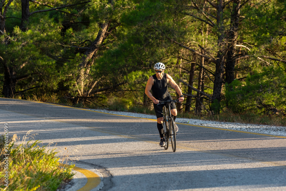 male biker cycling on a mountain road male biker cycling on a mountain road