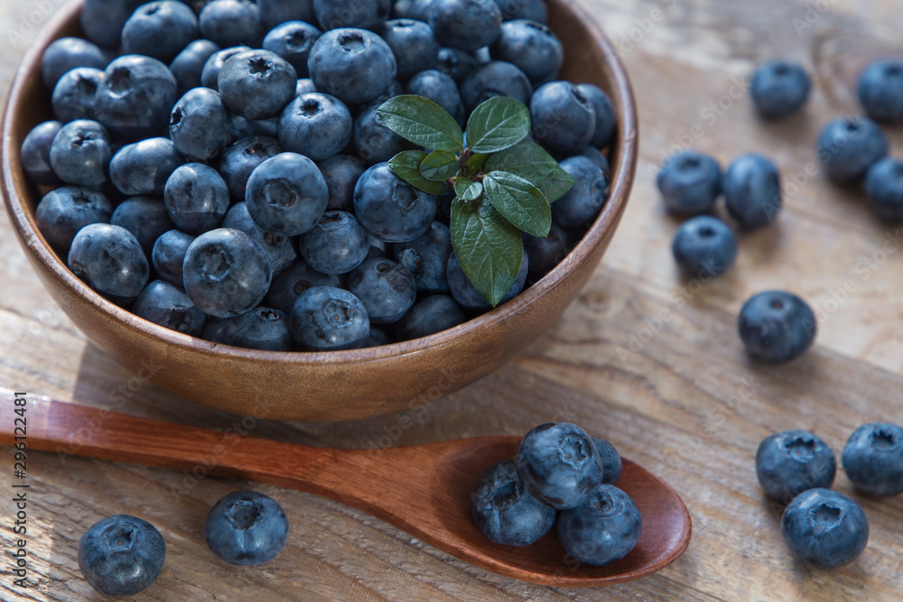 blueberries in a bowl on wooden table blueberries in a bowl on wooden table