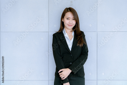 Photography Asian beatiful young business woman in suit skirt using tablet to work about sal