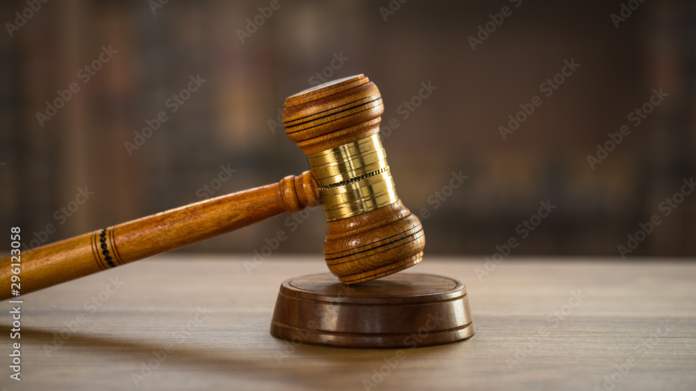 Law and Justice concept. Mallet of the judge, books, scales of justice. Courtroom theme.