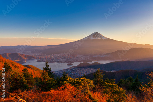 Aerial view of Mountain Fuji with morning mist or fog at sunrise in Fujikawaguchiko, Yamanashi, Japan. Mountain Fuji and Kawaguchiko lake in early morning seen from Shindo toge view point.