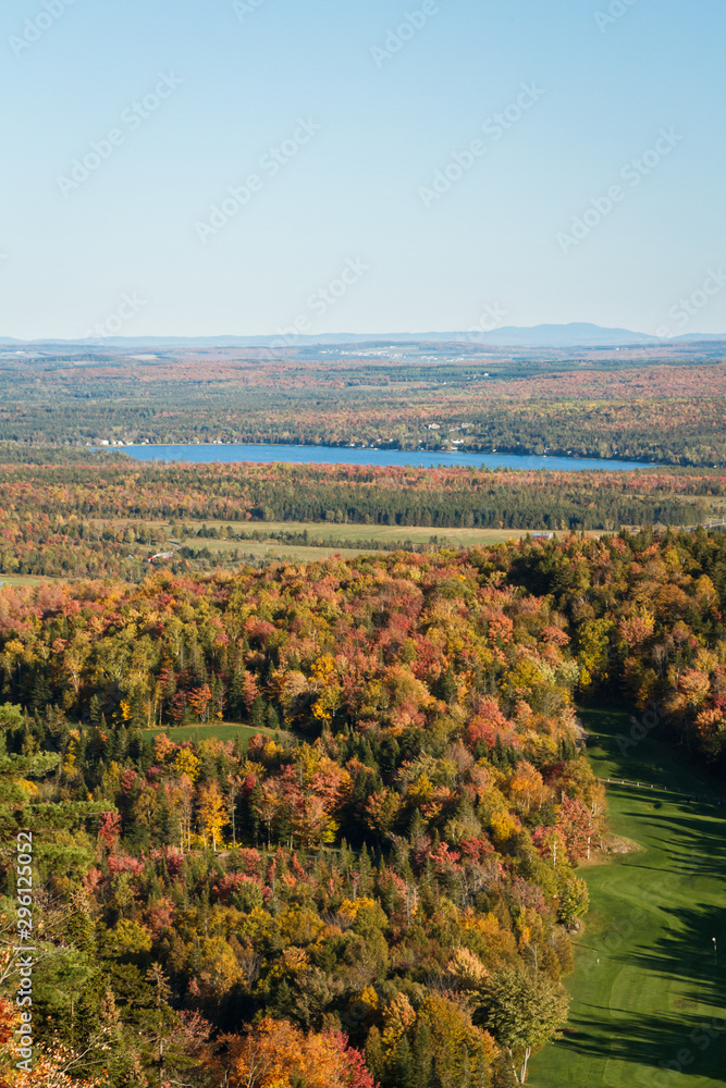 Lake, golf course and mountains in autumn viewed from Mount Adstock, Canada