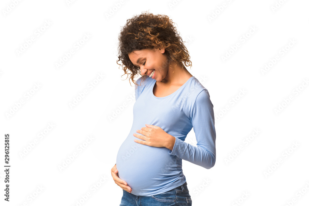 Afro woman feeling unity with unborn child Afro woman feeling unity with unborn child