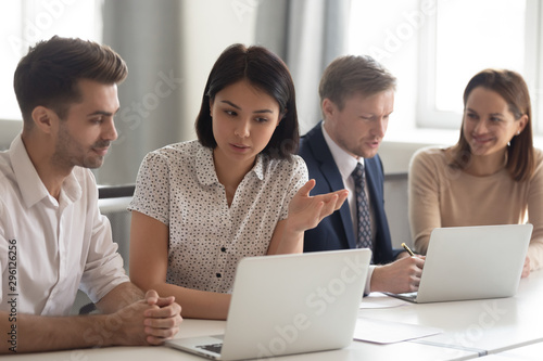 Asian businesswoman mentor teaching male employee  using laptop