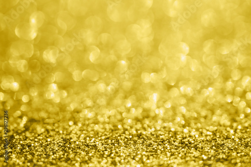 Abstract blur gold glitter sparkle defocused bokeh light background © Kwangmoozaa