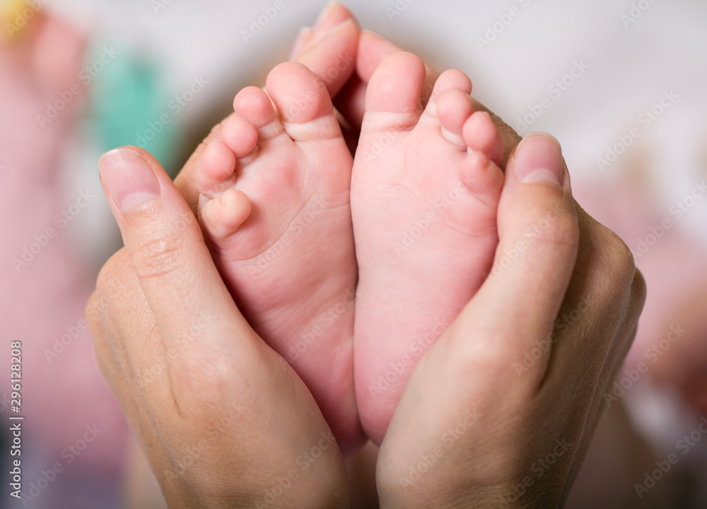 Newborn baby feet mother hands in heart , concept tenderness care mom dad love Newborn baby feet mother hands in heart , concept tenderness care mom dad love