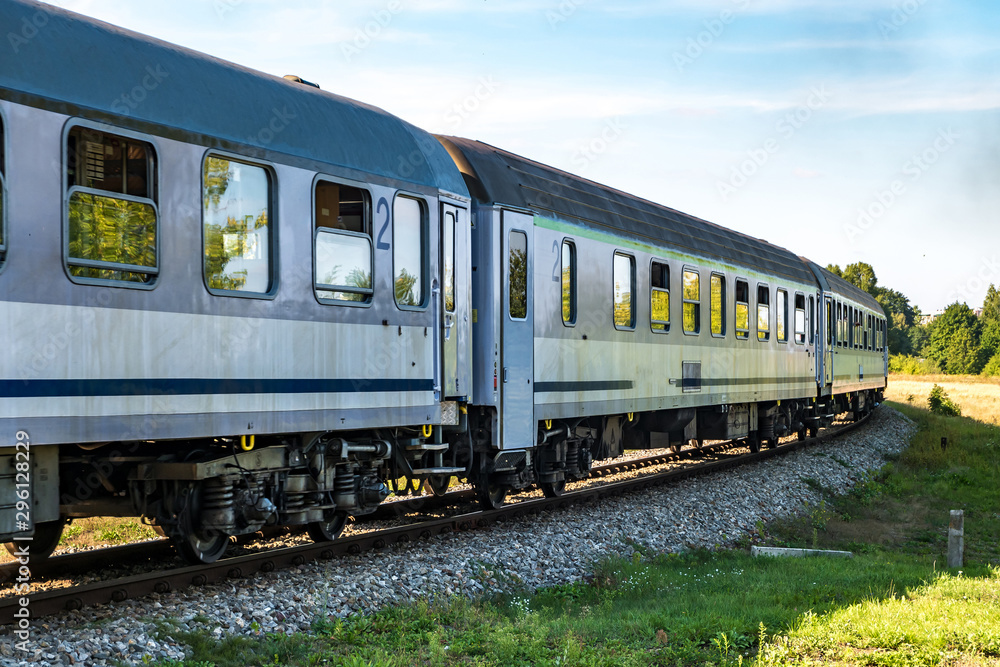 passenger train rides among fields on a sunny day passenger train rides among fields on a sunny day