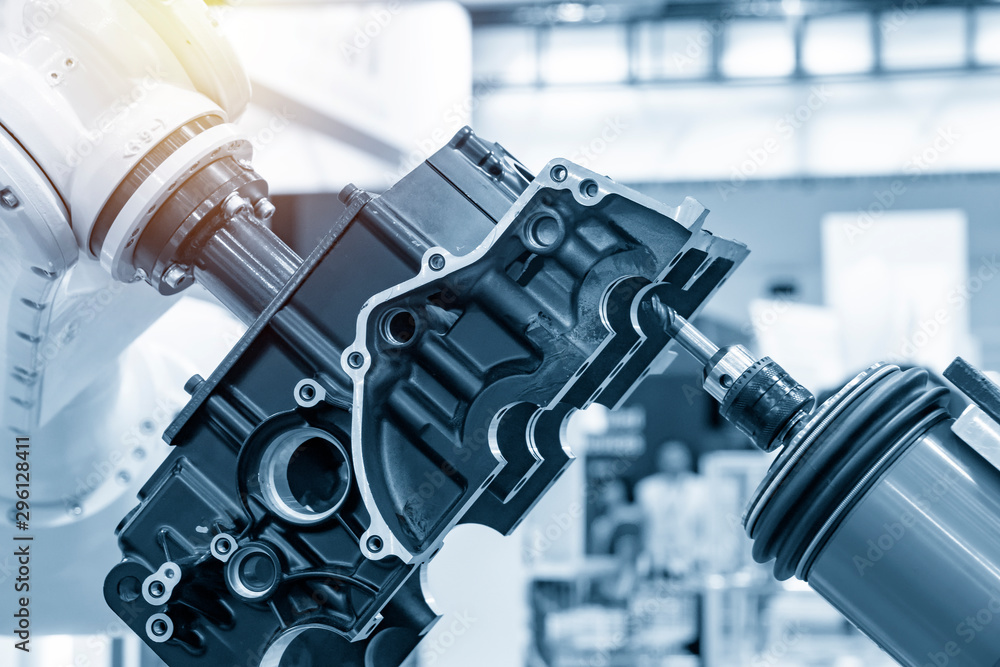 The automotive parts finishing process by milling spindle with the robotic  arm. The aluminium casting gearbox parts machining process by automatic  robotic system attach the milling spindle . Stock Photo | Adobe Stock