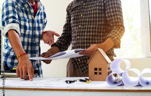 Team Engineers are writing solar panel for home construction designs to bring them to prospective customers.concept