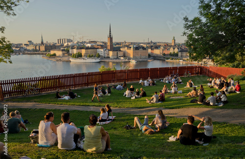 Young people picnic at sunset in the Summer in the fashionable Södermalm neighbourhood and district of Stockholm; Sweden