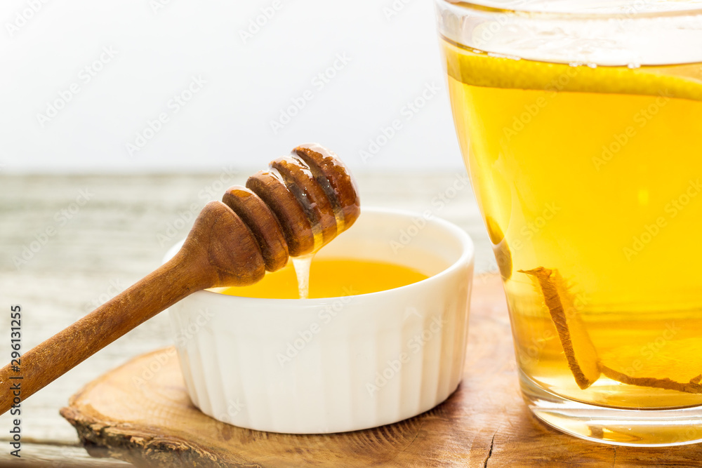 Ginger tea with lemon and honey on a white wooden background. Hot healthy winter drink Ginger tea with lemon and honey on a white wooden background. Hot healthy winter drink
