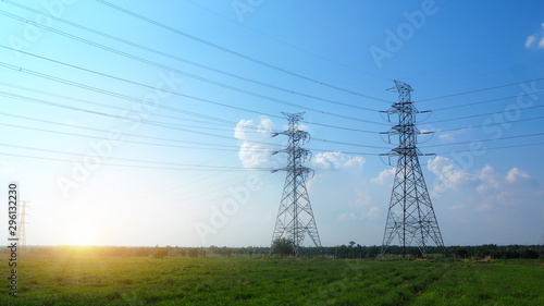 high voltage post or high voltage tower sky sunset and green meadow use for electrical transmission system background or banner concept, landscaping shot photo.