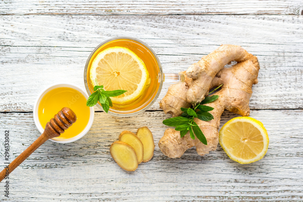Ginger tea with lemon mint and honey on a white wooden background. Hot healthy winter drink Ginger tea with lemon mint and honey on a white wooden background. Hot healthy winter drink