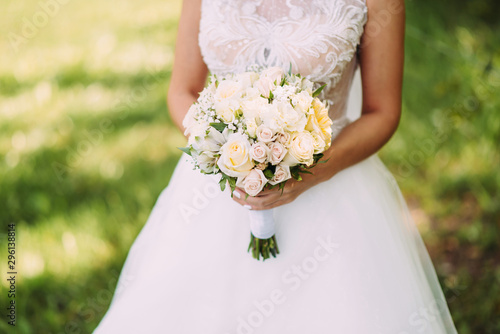Wedding bouquet in bride's hands. Close-up. Wedding Accessories Bride