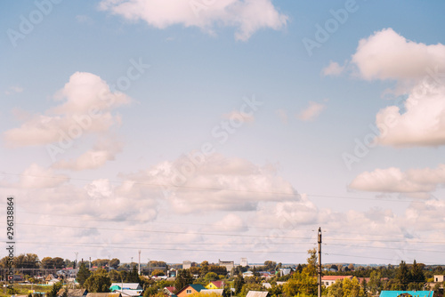 Country landscape. Beautiful sky over the field and village houses