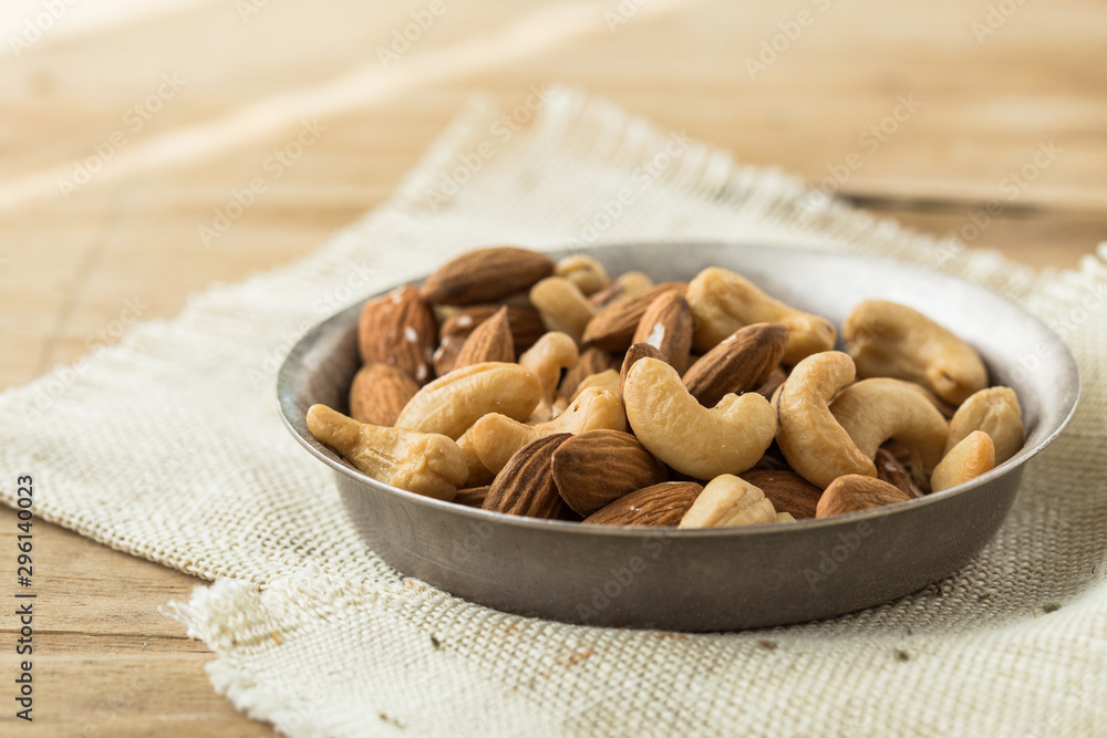 Nuts Mixed in a wooden plate.Assortment, Walnuts,Pecan,Almonds,Hazelnuts,Cashews,Pistachios.Concept of Healthy Eating.Vegetarian.selective focus. Nuts Mixed in a wooden plate.Assortment, Walnuts,Pecan,Almonds,Hazelnuts,Cashews,Pistachios.Concept of Healthy Eating.Vegetarian.selective focus.