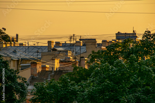 A wonderfully atmospheric view of the roofs of houses at sunset.