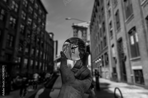  lensball view of one of the towers of the Manhattan Bridge from the streets of the DUMBO district, Brooklyn, NYC black and white, crystal ball image
