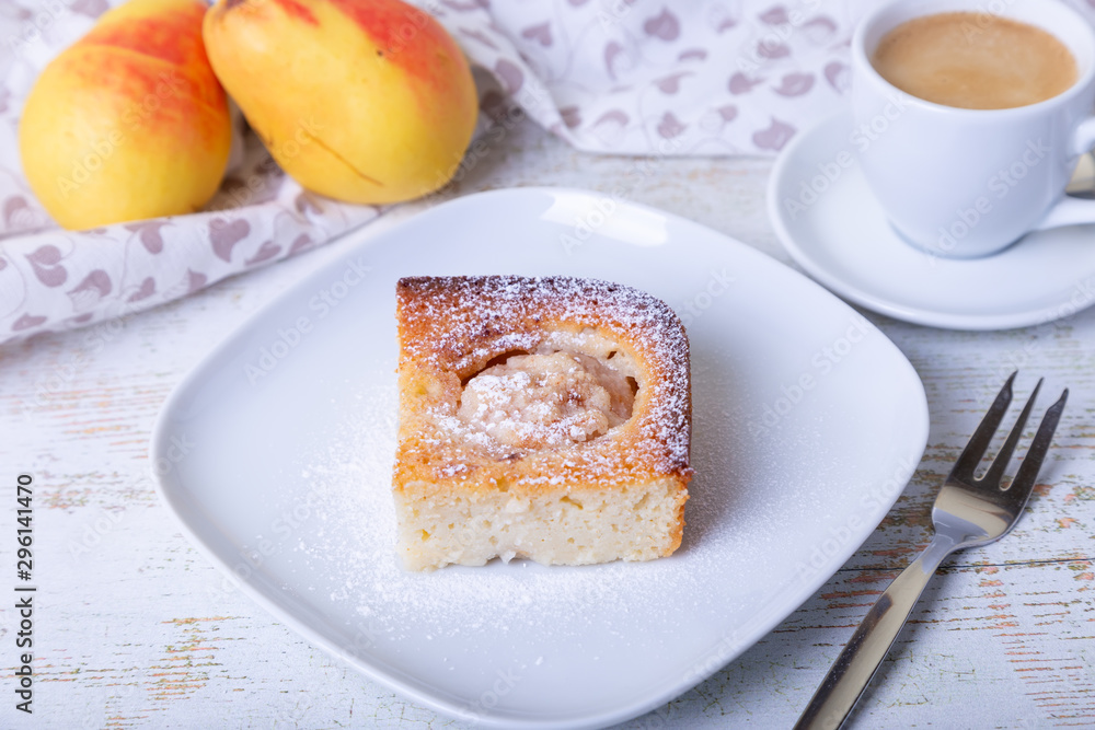 Mannik (Semolina pie) with pear and canella. In the background is a cup of coffee and fresh pears. Traditional Russian cuisine. Close-up, selective focus. Mannik (Semolina pie) with pear and canella. In the background is a cup of coffee and fresh pears. Traditional Russian cuisine. Close-up, selective focus.