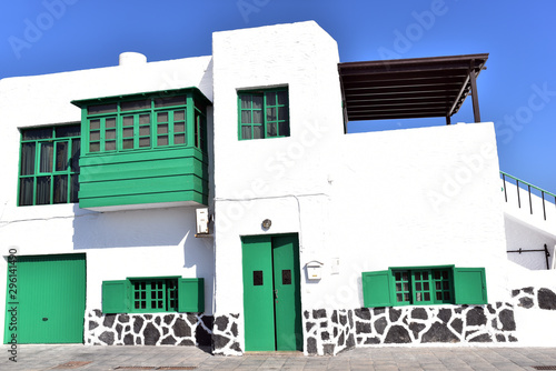 Old green wooden door and windows on white washed building in La Cruz, Teguise, Lanzarote, Canary Islands, Spain