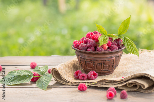 Fototapeta Naklejka Na Ścianę i Meble -  raspberry in basket  on natural background, summer food concept 