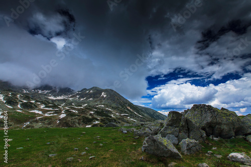 Beautiful spring scenery in the Transylvanian Alps, with ominous storm clouds