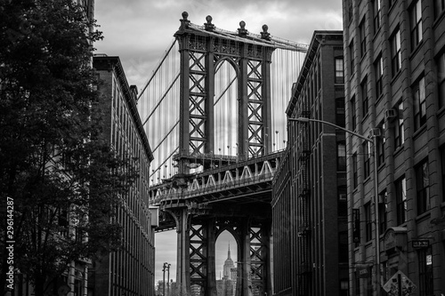 View of one of the towers of the Manhattan Bridge from the streets of the DUMBO district, Brooklyn, NYC black and white © FitchGallery