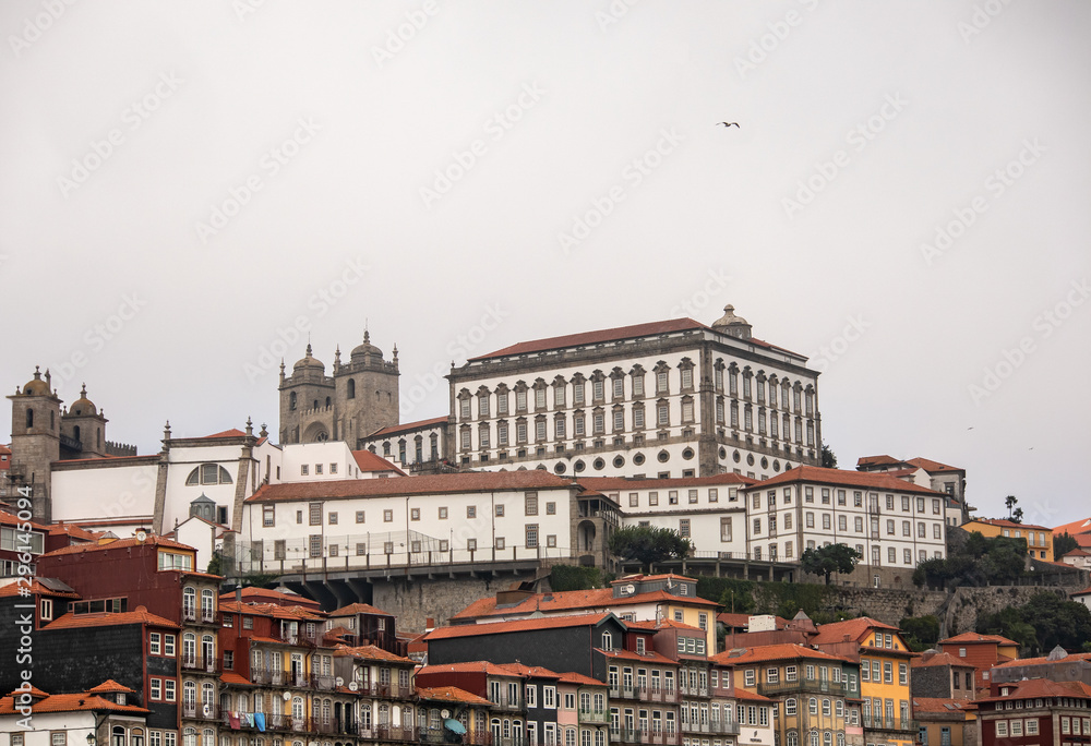 Cityscape image of Porto, Portugal, with old town Ribeira at foggy afternoon