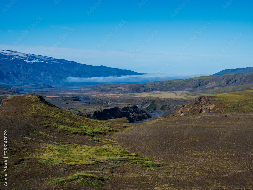 Icelandic landscape with blue Markarfljot river canyon, green hills and eyjafjallajokull volcano glacier. Laugavegur hiking trail. Fjallabak Nature Reserve, Iceland. Summer blue sky