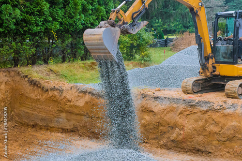 Industrial construction of foundation excavator moving gravel for building
