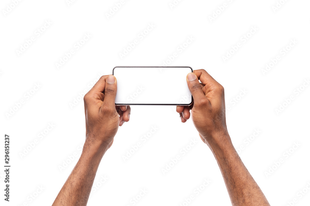 Man's hands holding smartphone with blank screen, playing video games Man's hands holding smartphone with blank screen, playing video games