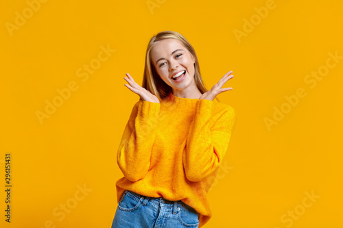 Portrait of young carefree girl on orange background © Prostock-studio
