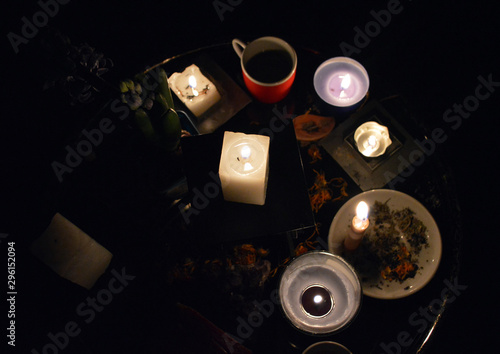 Magic flowers, ritual objects, candles on witch table. Occult, esoteric and divination concept.