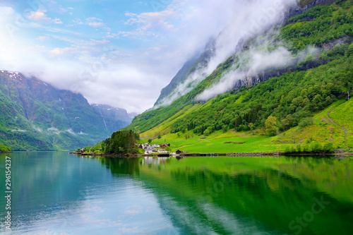 Beautiful idyllic landscape of the fjord Naeroyfjord in Gudvangen, Norway. A small traditional Scandinavian village on the picturesque coast of the fjord between the mountains. Travel background