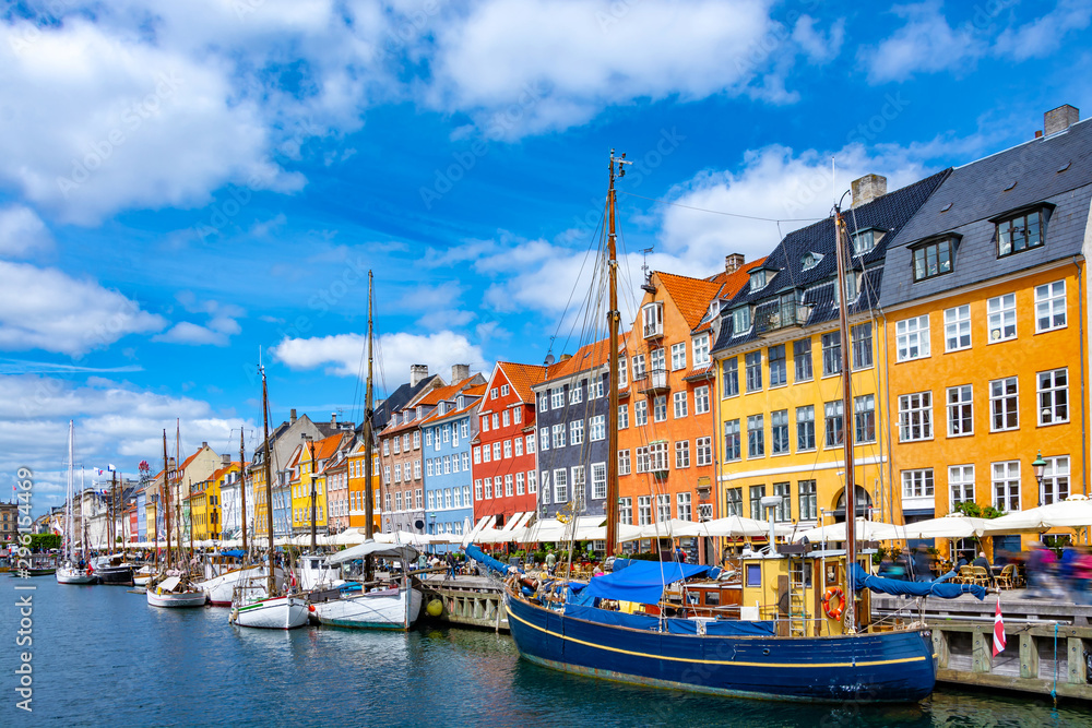 Scenic summer view of Nyhavn pier with colorful buildings and boats in Old Town of Copenhagen, Denmark