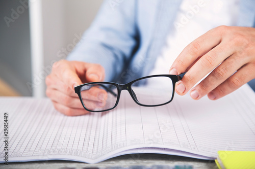 man hand glasses on document