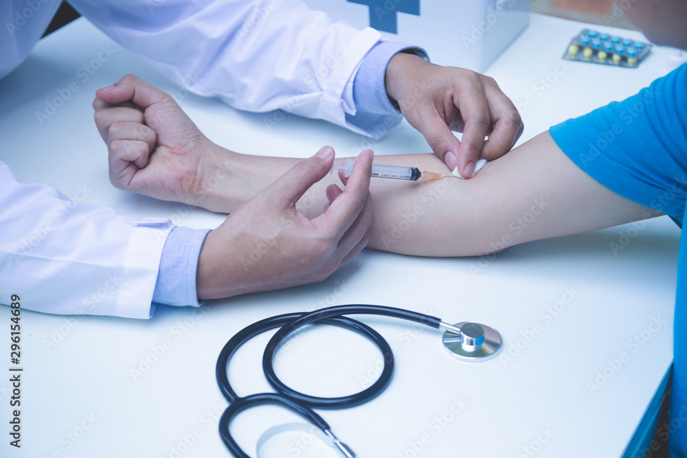 Doctor giving patient vaccine,Selective focus,Doctor inject vaccine to patient. Doctor giving patient vaccine,Selective focus,Doctor inject vaccine to patient.