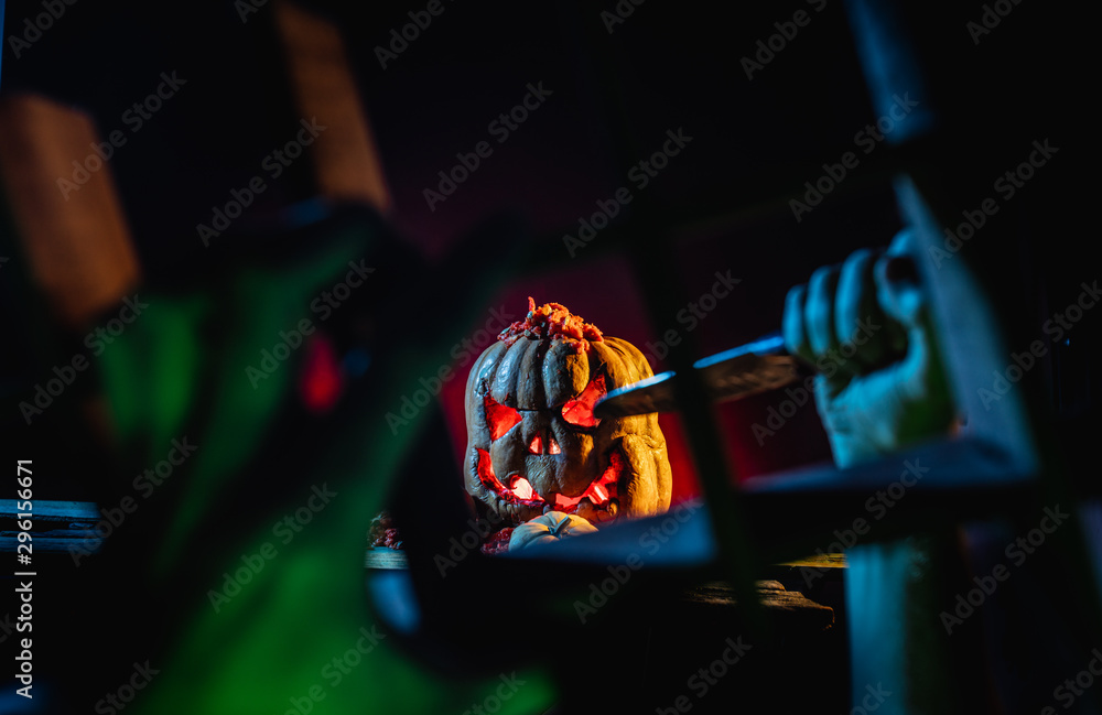 Scary Halloween pumpkins with hands in a spooky place at night. Poster concept.