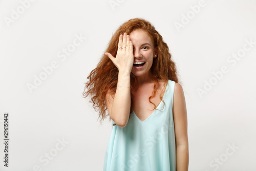 Young smiling redhead woman in casual light clothes posing isolated on white wall background studio portrait. People sincere emotions lifestyle concept. Mock up copy space. Covering face with hand.