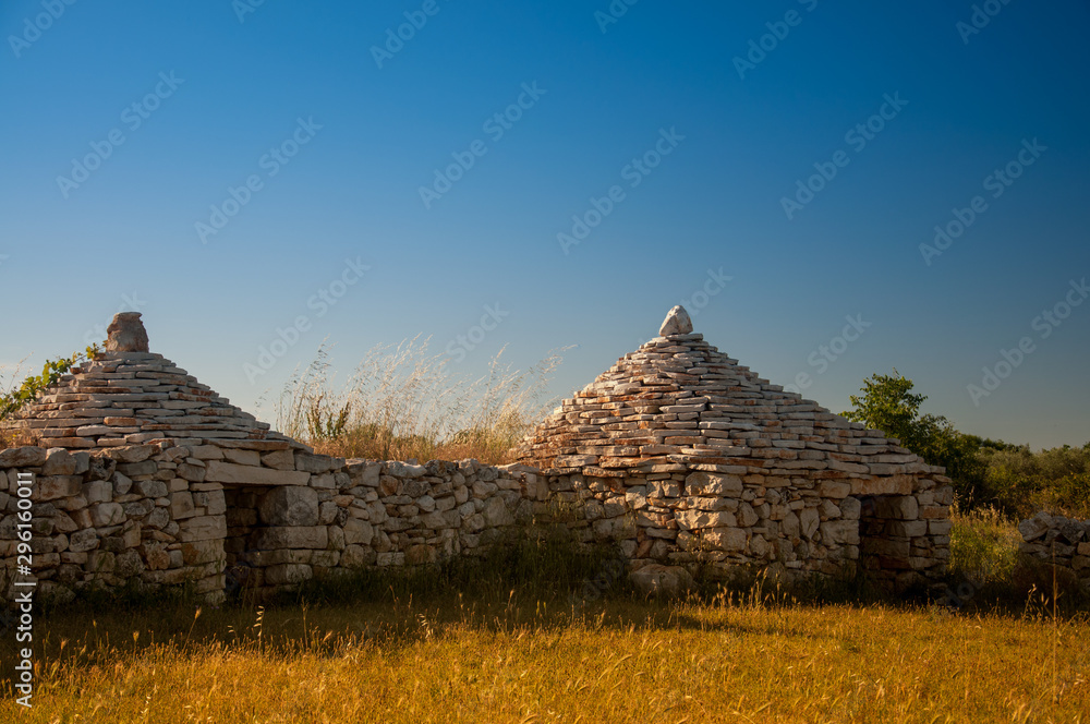 Two traditional istrian huts - Kazun. Blue sky in background. Two traditional istrian huts - Kazun. Blue sky in background.
