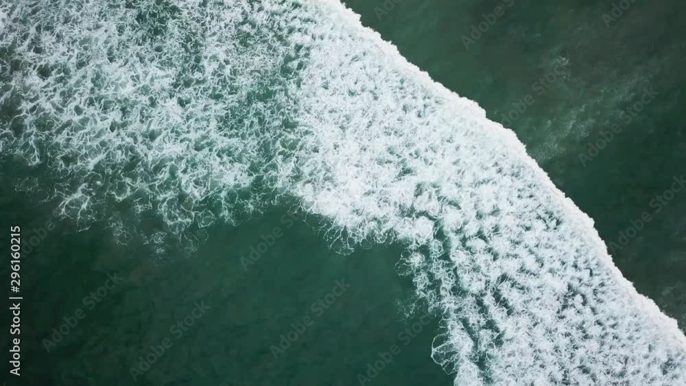 waves breaking on the shore in deep blue water waves breaking on the shore in deep blue water