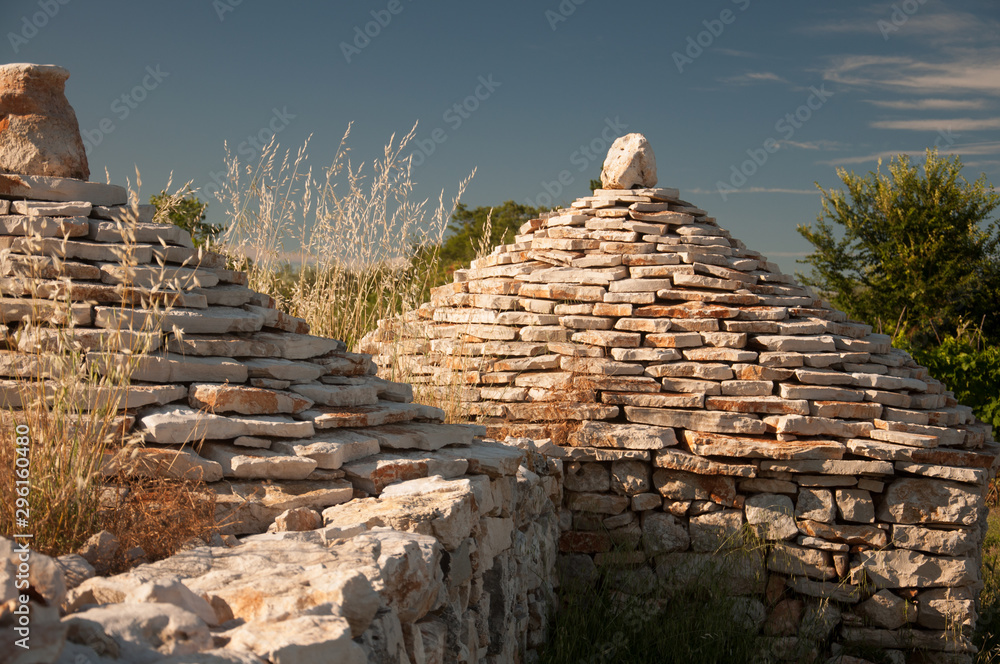 Close up of two traditional istrian huts - Kazun. With blue sky in background.